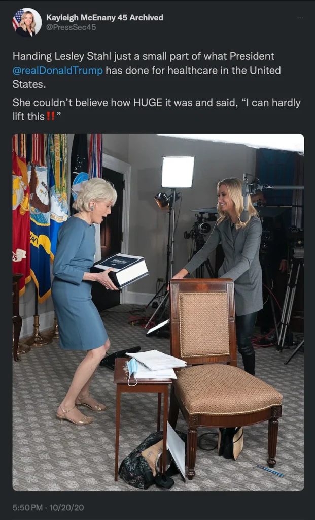 Reporter holding Trump-Care health plan book
